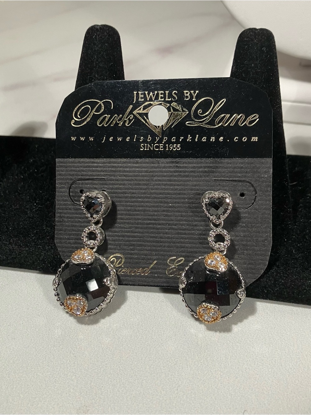 Bellisimo earrings. Onyx like faceted center suspended from heart details.